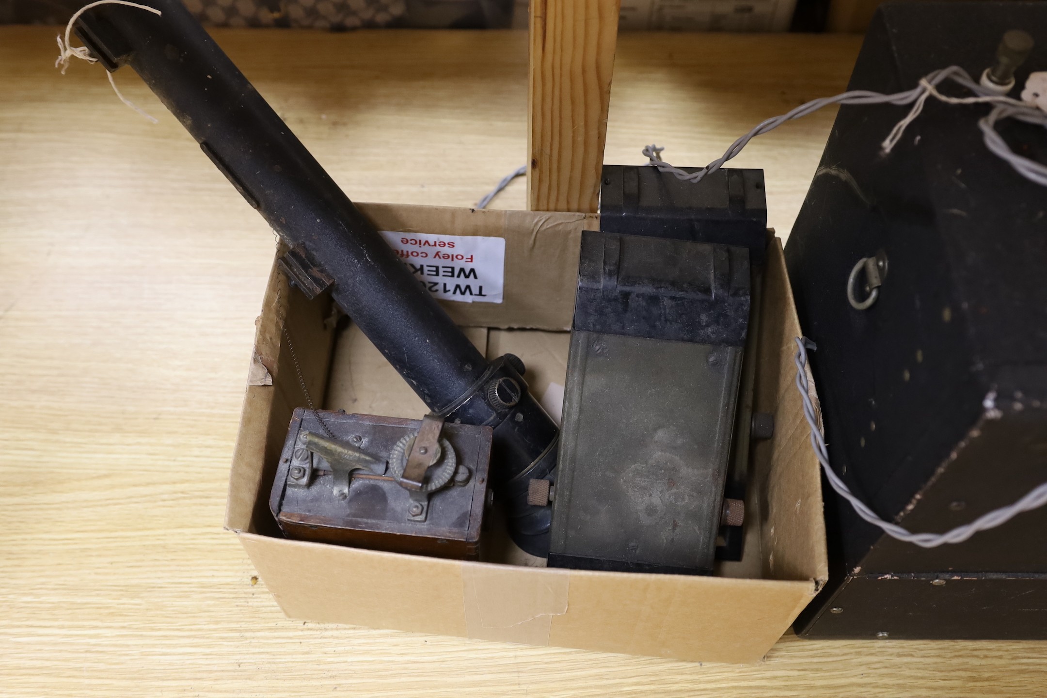 A collection of vintage military equipment, including a WWII British Tank Telescope Sight No. 33 MK III, two tank periscopes, a US Army Signal Corps Frequency Meter by Zenith and a Vandervell CAV Morse Code box (5)
